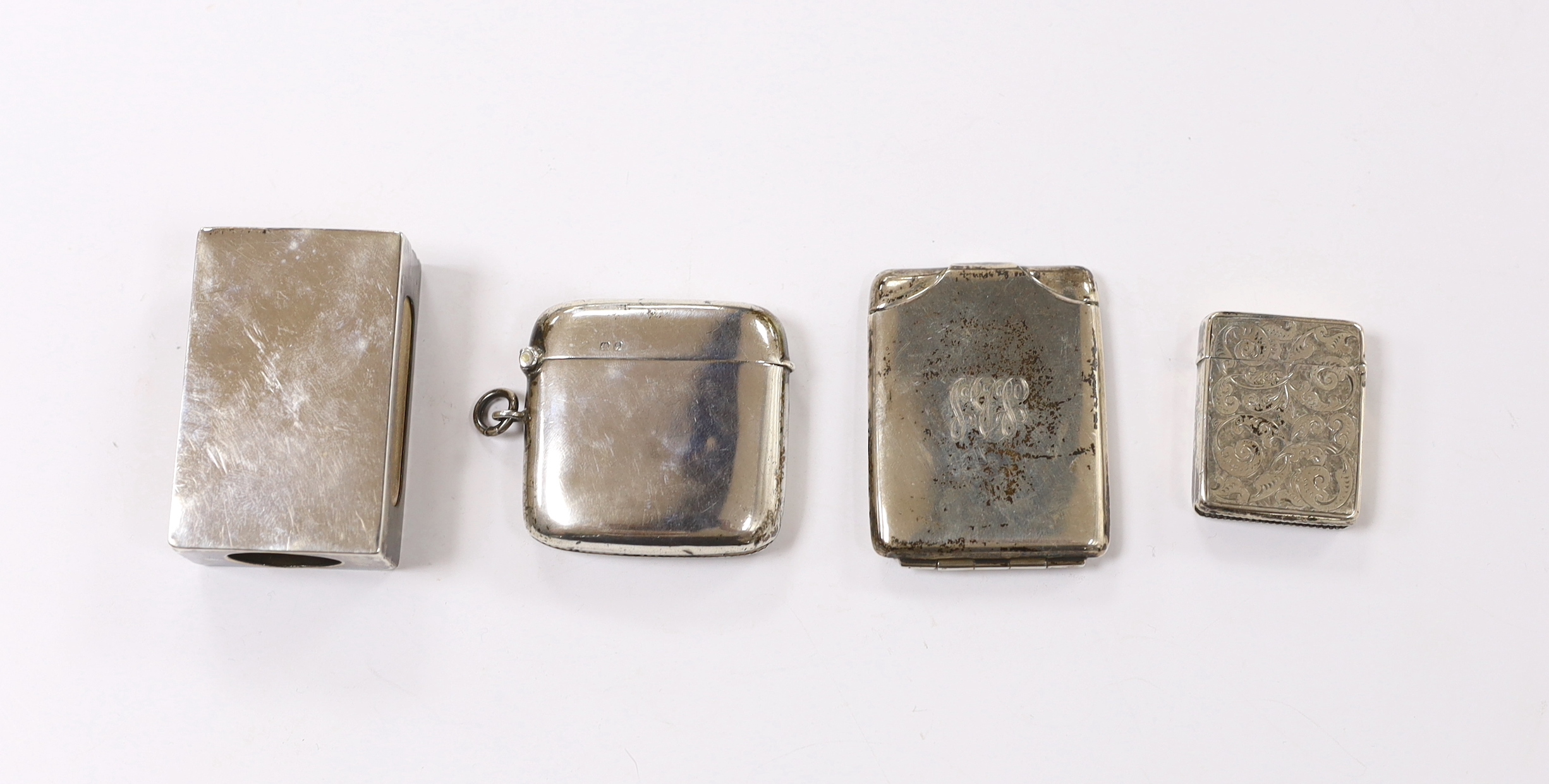 Two silver vesta cases, largest 49mm and two silver match sleeves.
